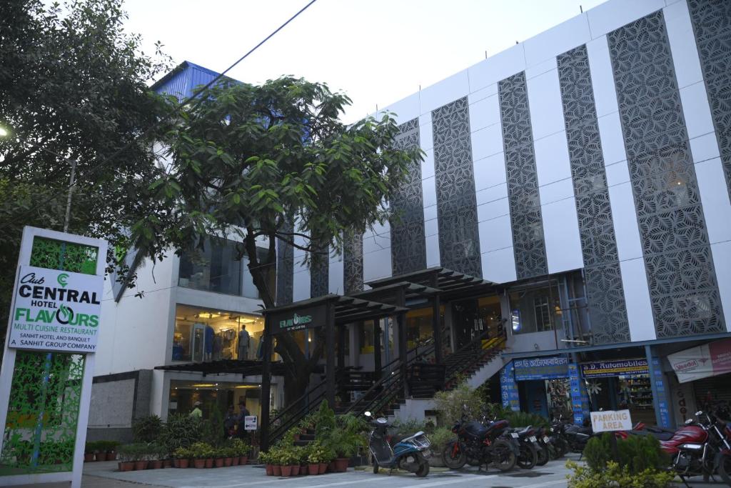 a building with motorcycles parked in front of it at Club Central in Bolpur
