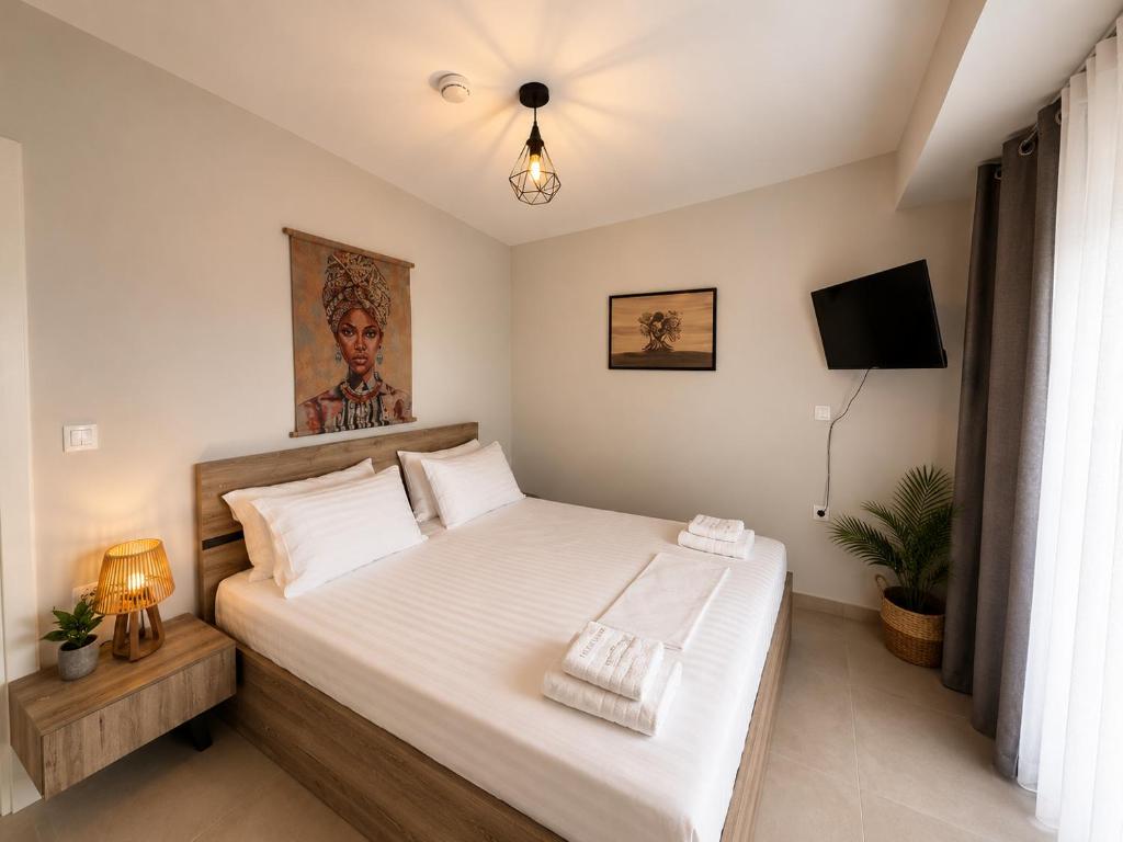 a bedroom with a large bed with white sheets at Aelia Blu 2 Maisonette in Ofrínion