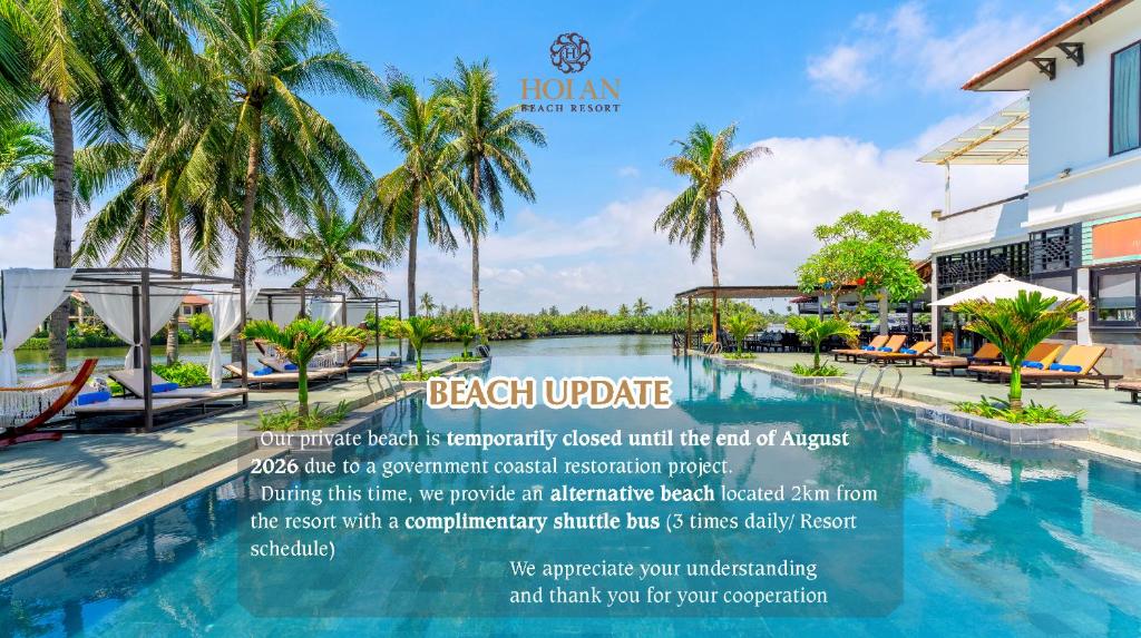a resort with a swimming pool and palm trees at Hoi An Beach Resort in Hoi An