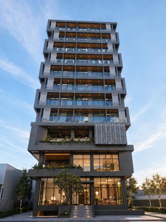 a tall building with a lot of windows at One Studio Suite by PSH in Krong Poi Pet
