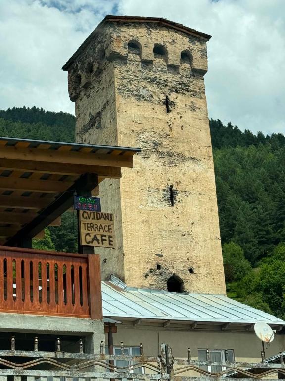a building with a tower on top of it at Guest House Gvidani In Lakhiri in Mestia