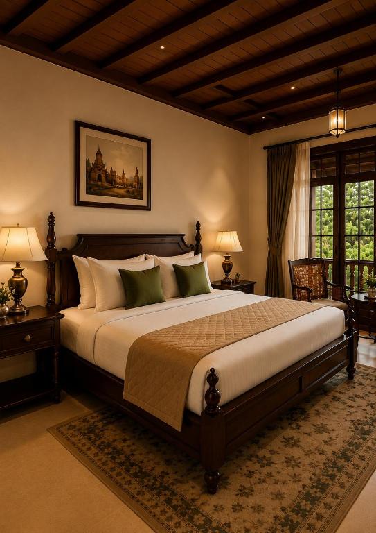 a bedroom with a large bed in a room at Vox Valavan in Kuttālam