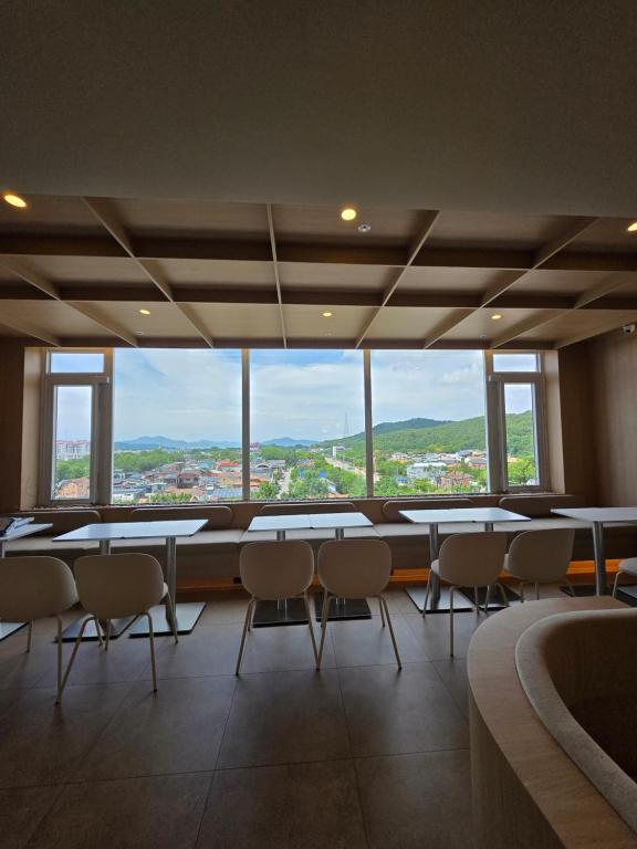 a room with tables and chairs and a large window at Mare Suite Hotel in Incheon
