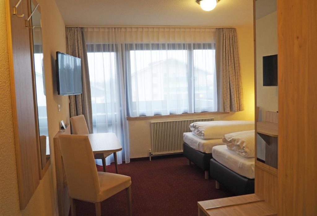Postel nebo postele na pokoji v ubytování Hotel Restaurant Rössle