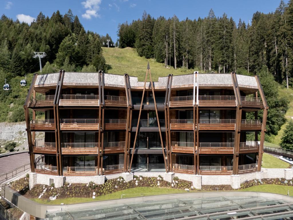 an external view of a building with trees at Campiglio PLAZA in Madonna di Campiglio