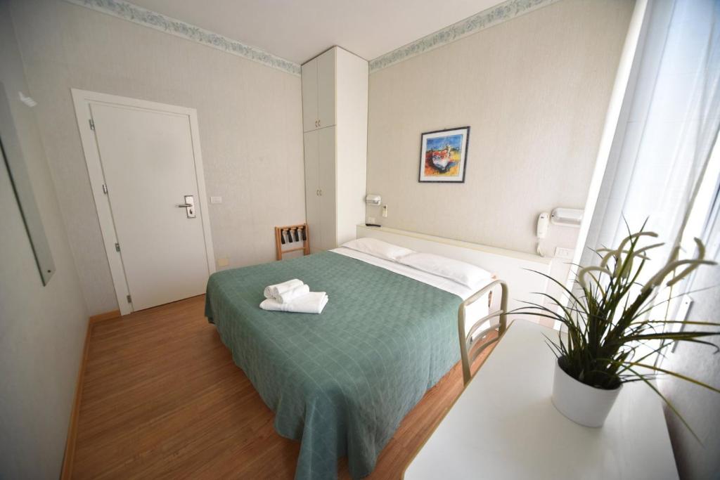Postel nebo postele na pokoji v ubytování Hotel Villa Edda