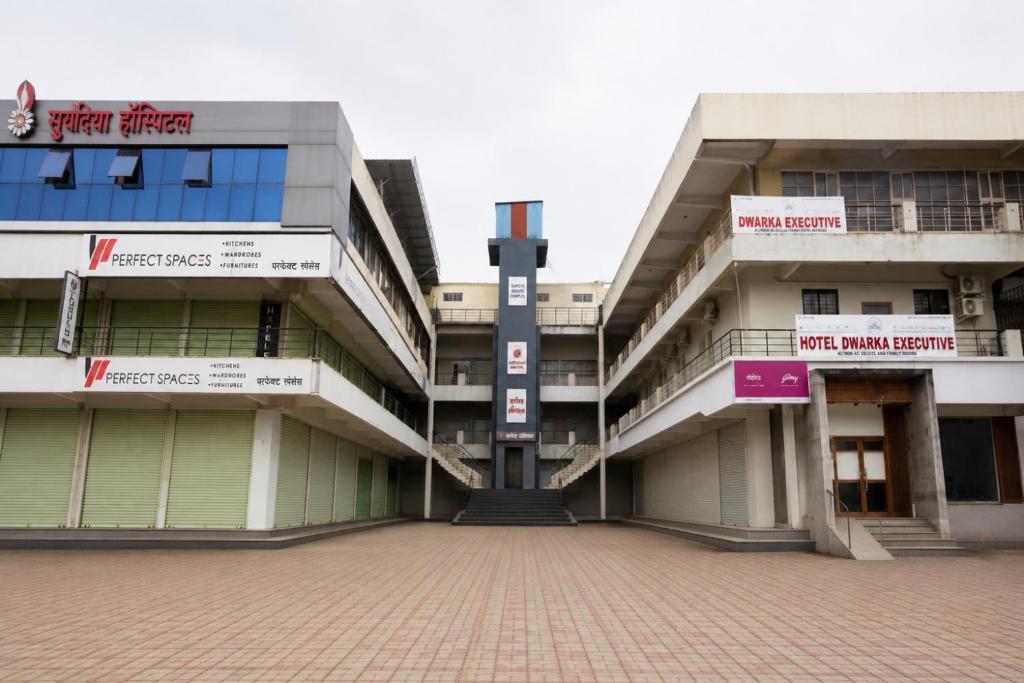 an exterior view of a building with a courtyard at Hotel Dwarka Executive in Nashik