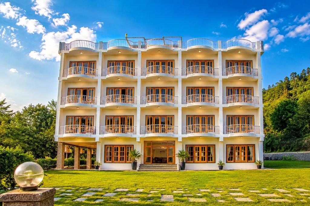 a large building with a lawn in front of it at Swaasha Vista in Kausani