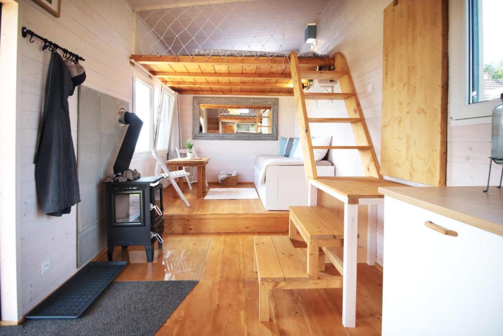 a tiny house with a wood stove in a room at Tiny house U Dlouháče in Litoměřice