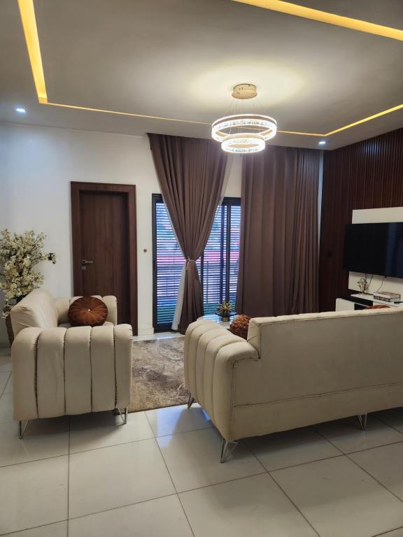 a living room with two couches and a television at De Atrium apartment in Galadima