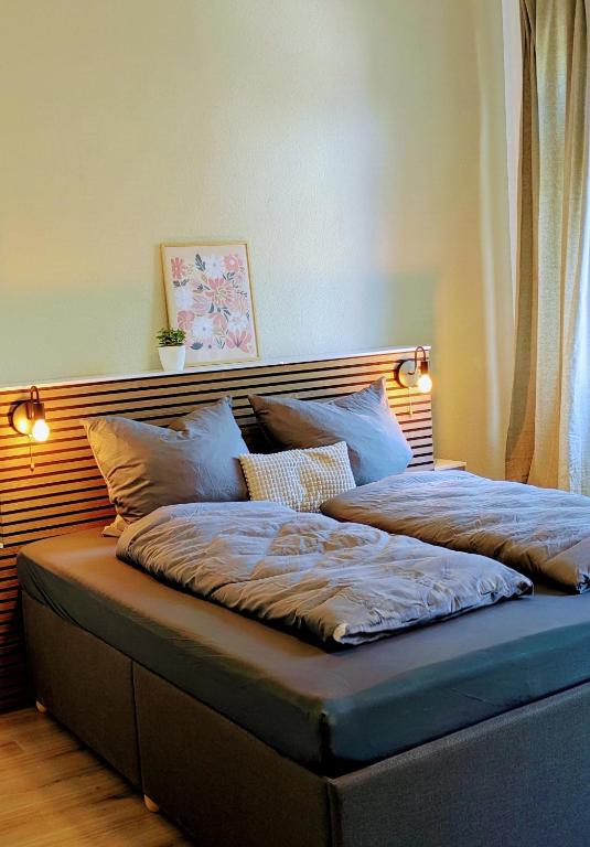 a bed with two pillows on top of it at Gasthof Schausten in Kreuztal
