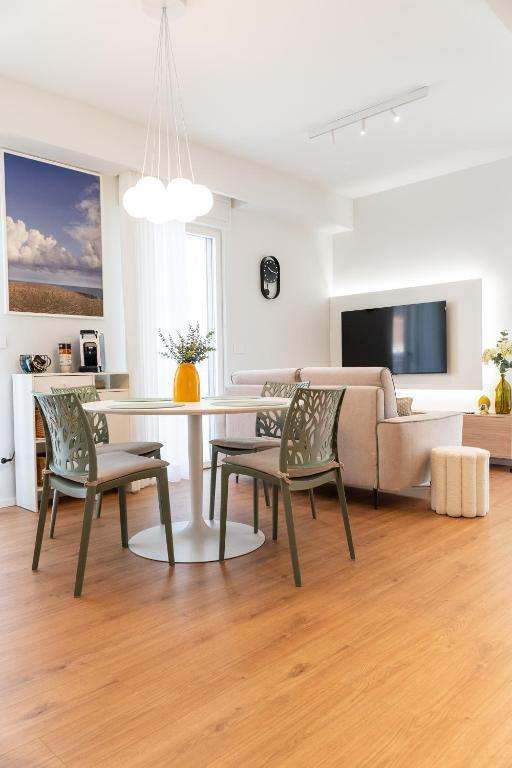 a living room with a table and chairs and a couch at DELL'EDERA Luxury Home in Polignano a Mare