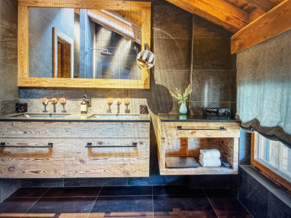 a bathroom with a sink and a mirror at Arlberg View Residence in St. Moritz