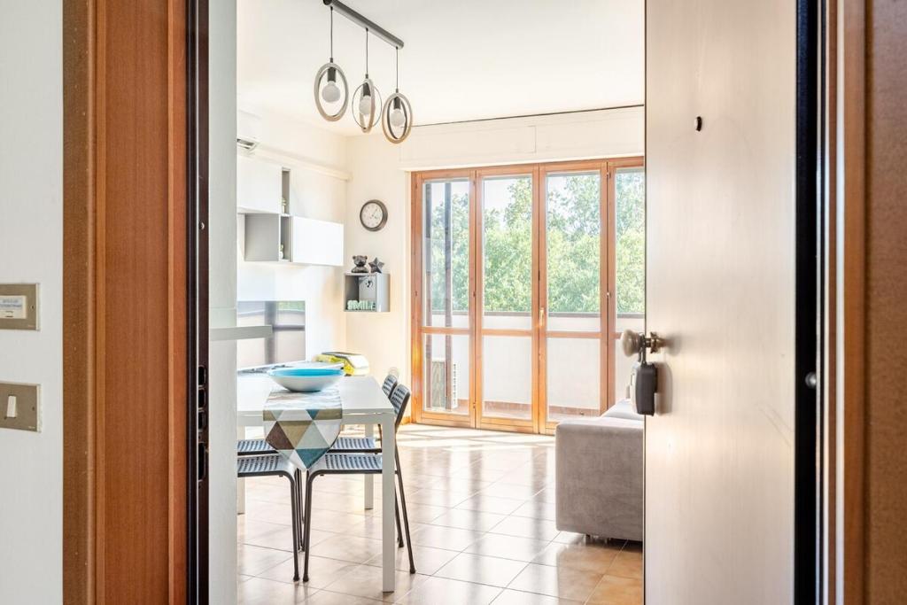 a kitchen and living room with a table and chairs at Soffio di Luce in Calderara di Reno