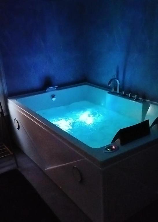 a bath tub in a room with a blue wall at Zen Lux in Zaječar