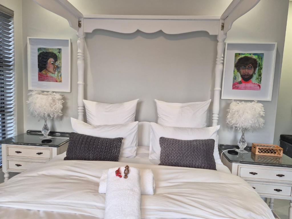 a bedroom with a white bed with a canopy at 8 Guildford in George