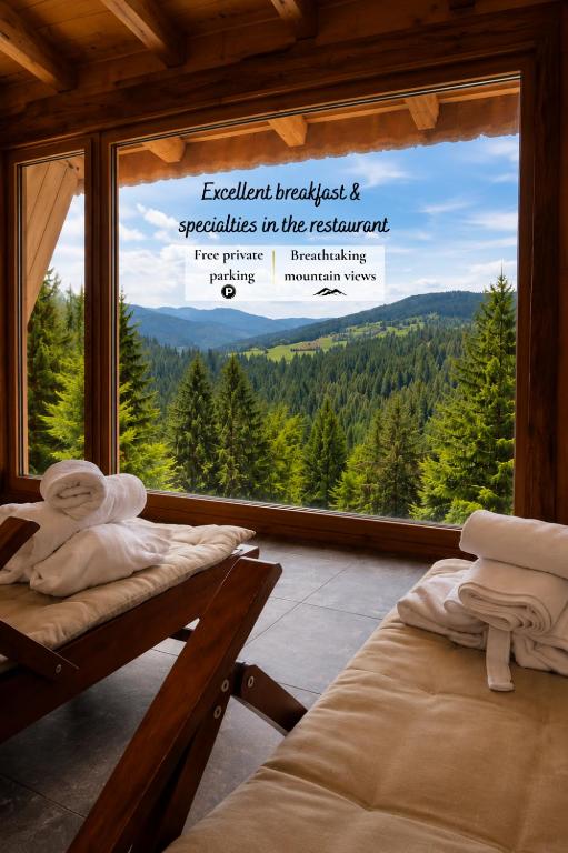 a room with two beds and a window with a view at Apartmaji Smogavc in Zreče