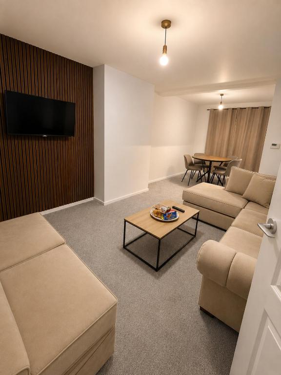 a living room with a couch and a table at Newly Refurbished 3-Bed Sleeps 5 in Lostock