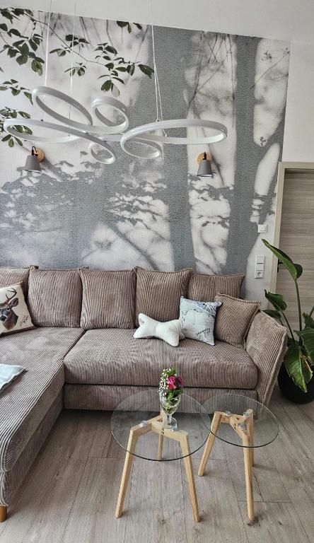 a living room with a couch and a table at Gartenbungalow Rhönherz in Hilders