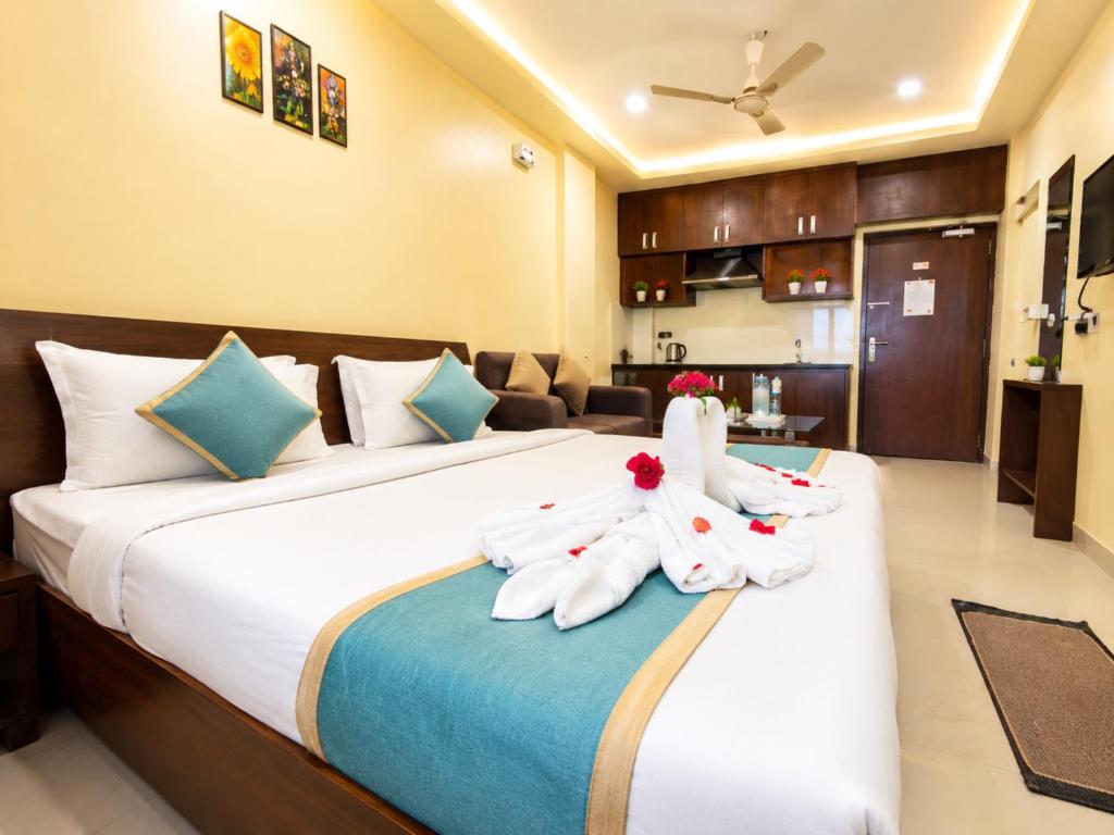 a hotel room with a bed with towels on it at Hotel Surya Resort in Sonepur