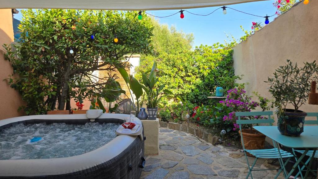 a backyard with a hot tub in a garden at Laure Cabasson in Bormes-les-Mimosas