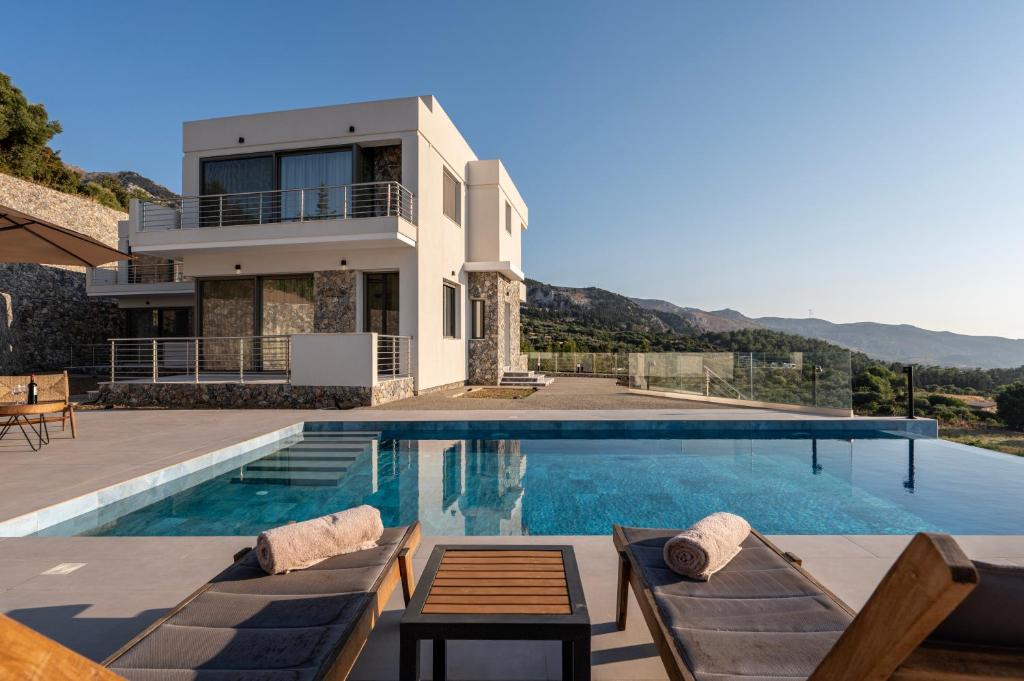 a villa with a swimming pool and a house at Sofia's Estates - Villa Athena -Adults Only- in Kos