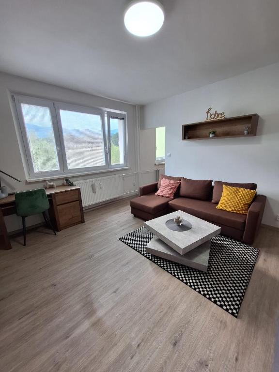 a living room with a couch and a table at Green Studio Martin in Martin