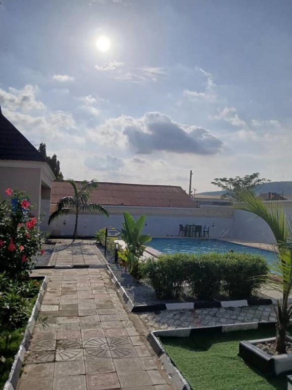 a backyard with a swimming pool and a resort at Stallion Luxury Suites Mararaba in Abuja