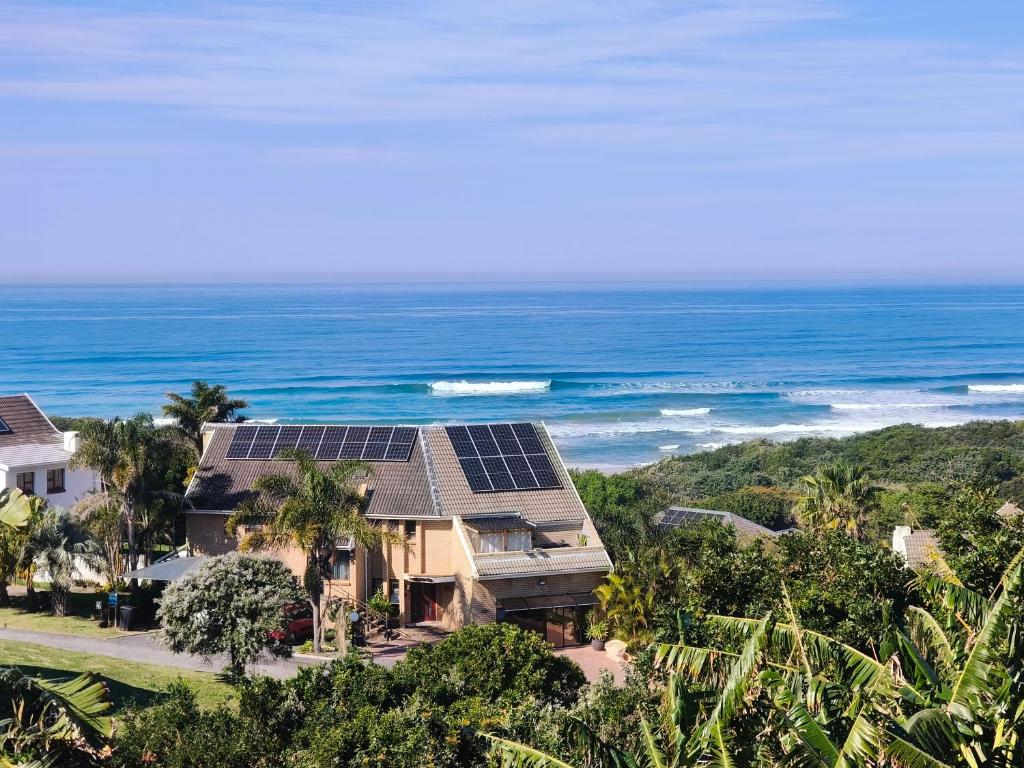 an aerial view of a house with solar panels on the roof at Cove Rock Stay in East London