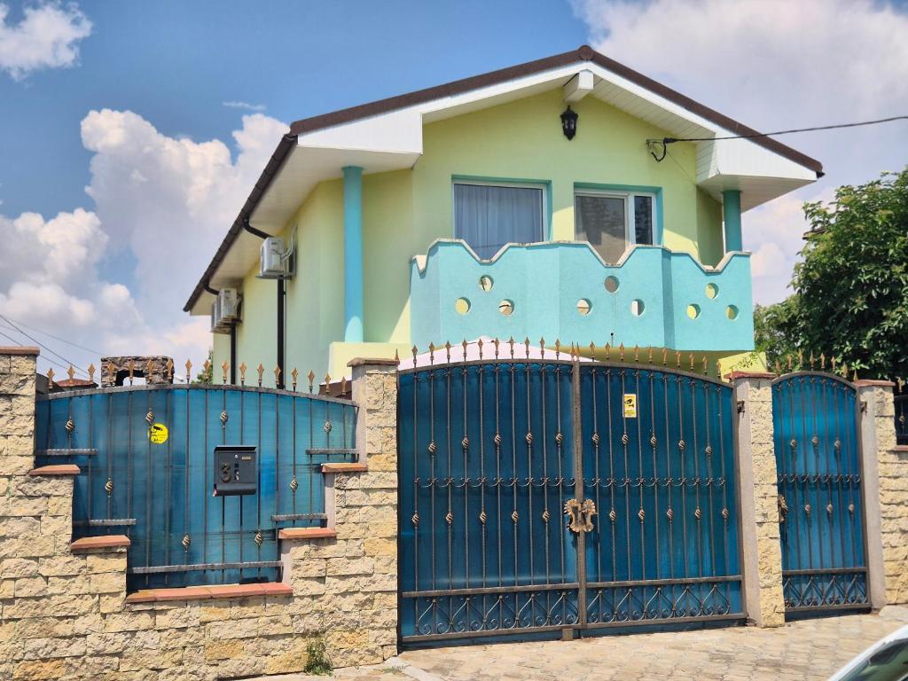 a blue gate in front of a house at Casa Elena in Eforie Sud