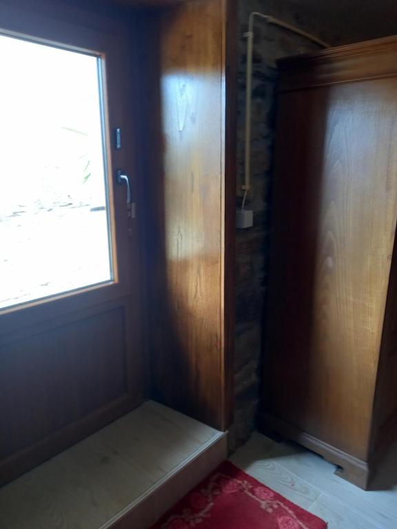 a door in a room with a window and a door at Casinha Meixedo in Bragança