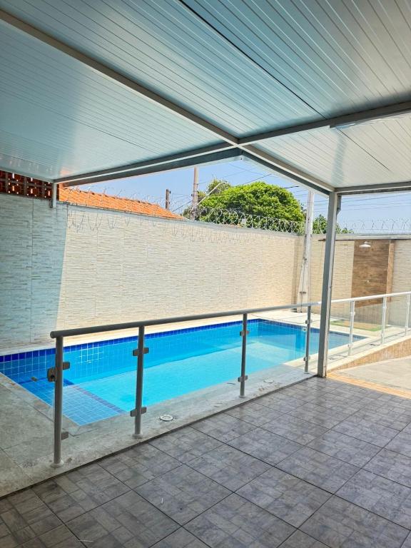 a view of a swimming pool under a roof at Área de Lazer in Limeira