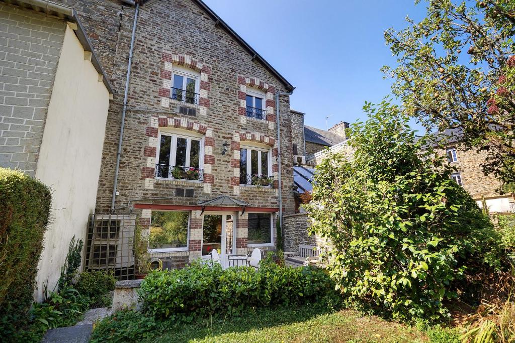 an old brick house with a porch and a yard at La Prairie de Vassy in Vassy