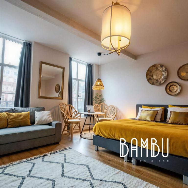 a bedroom with a bed and a couch at Bambu Kitchen & Bar - Hotel Restaurant in Haarlem