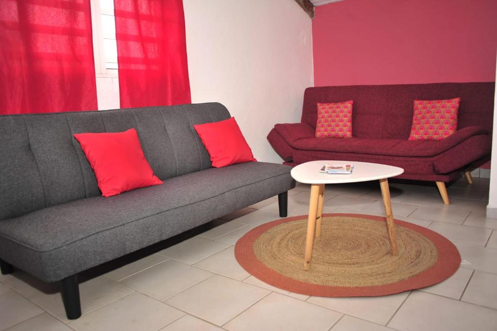 a living room with a couch and a table at Source de vie - Campagne in Capesterre-Belle-Eau