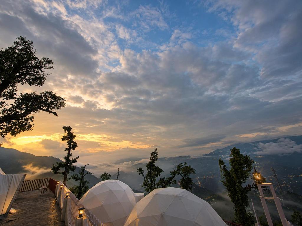a view of the sunset from a observatory in the mountains at The Edge Mountain Glamps & Luxury Domes Mussoorie in Mussoorie