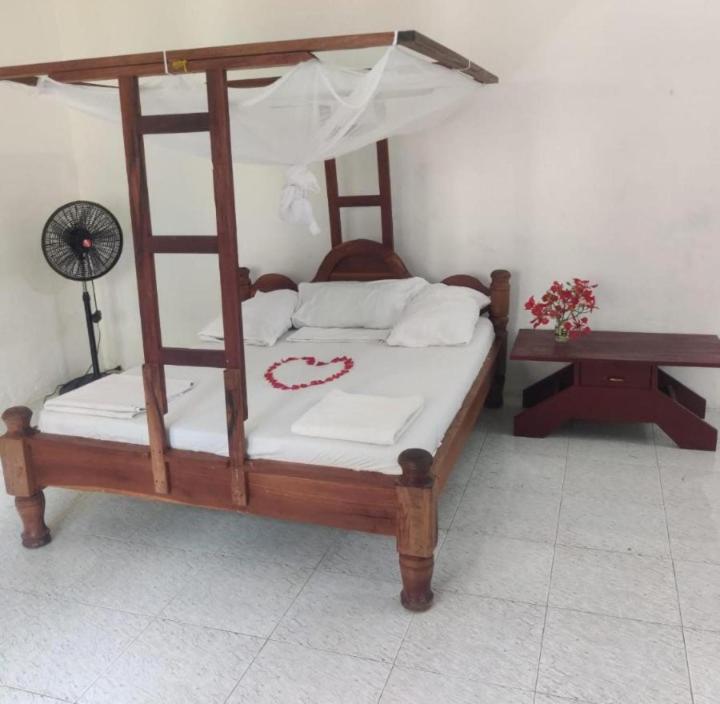 a bedroom with a wooden bunk bed and a table at Kwetu nungwi in Kinyasini