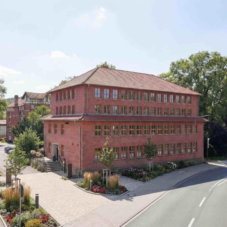 a large red brick building on a city street at Hotel Altes Sudhaus in Kassel