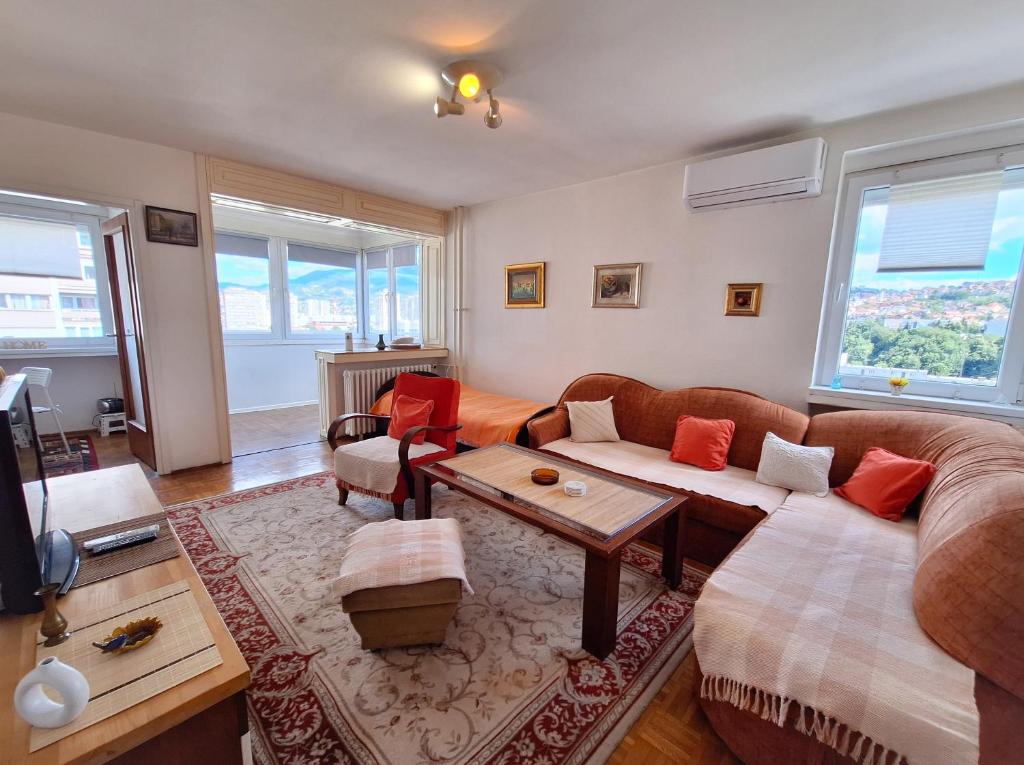 a living room with a couch and a table at Apartman Pasic in Sarajevo