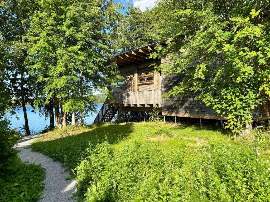 a tree house with a balcony on a hill at Kyly in Savonlinna