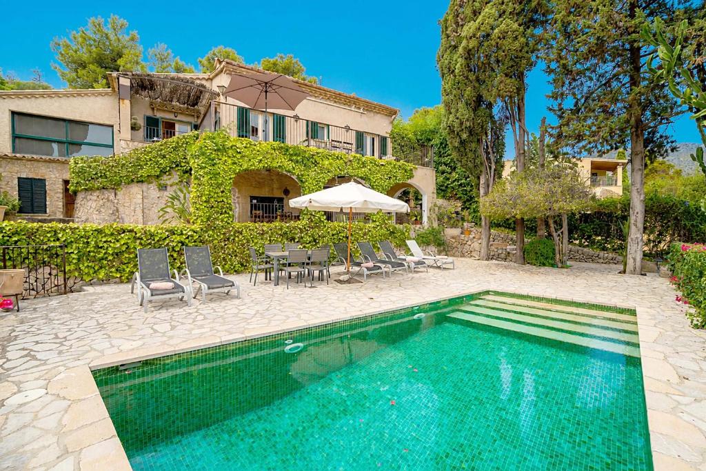 a swimming pool in front of a house at Villa Calvario by Sealand Villas in Pollença