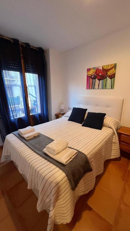 a bedroom with a large bed with towels on it at V.U.T. EL HONGO in Mora de Rubielos
