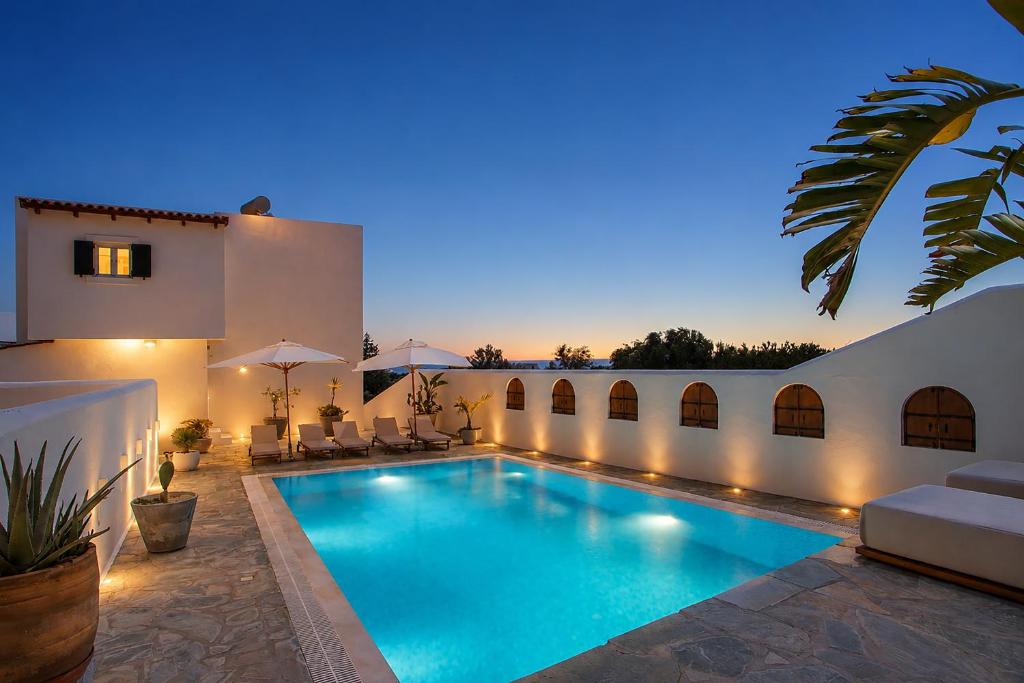 a swimming pool in the backyard of a house at Casa Evita in Gennadi