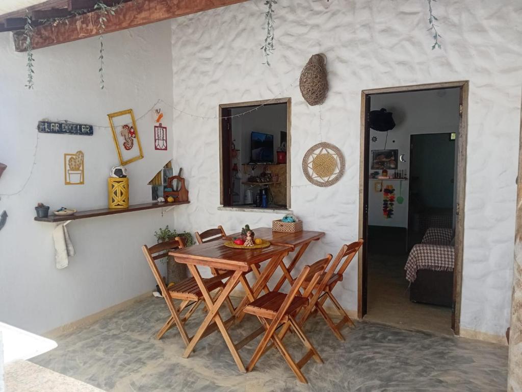a dining room with a wooden table and chairs at Chale Canoa Beach in Canoa Quebrada