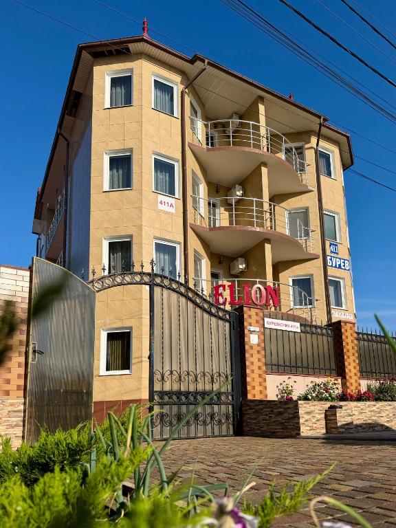 a building with a gate in front of it at Hotel Elion in Zatoka