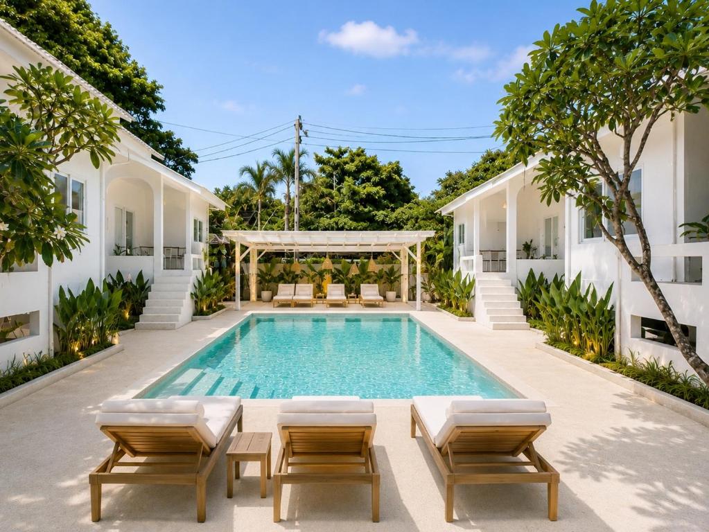 an outdoor swimming pool with chairs and a gazebo at Lavoe Villas Samui in Nathon Bay