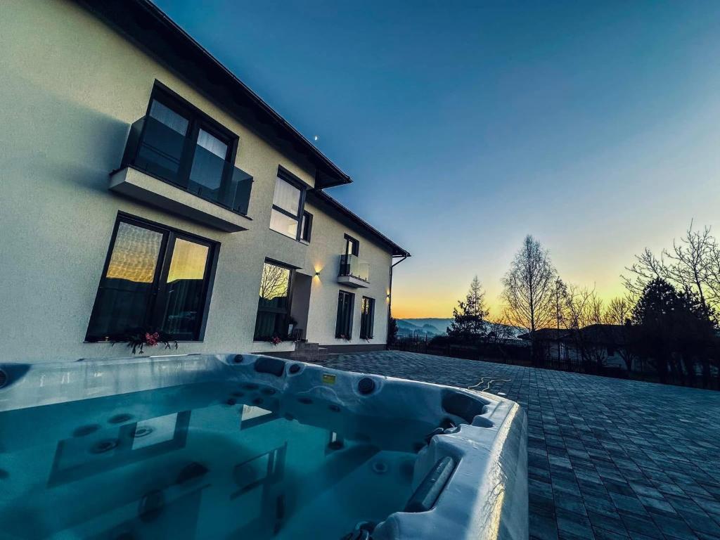 a swimming pool in front of a house at Vila Diamond Lux&Spa in Sovata
