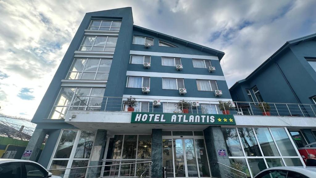 a blue building with a hotel atiths at Hotel Atlantis in Tulcea