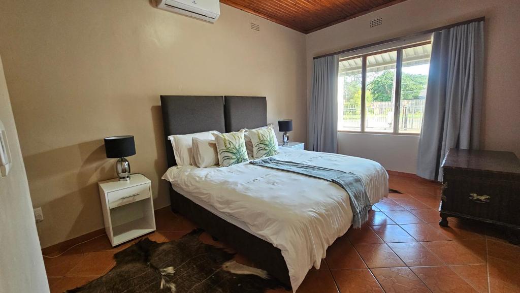 a bedroom with a large bed and a window at Fisherman's 6-Bedroom Family Home in St Lucia