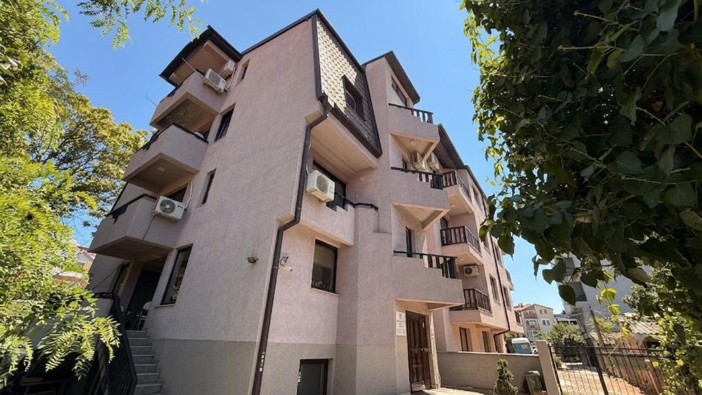 a building with balconies on the side of it at Drenak Hostel in Skopje